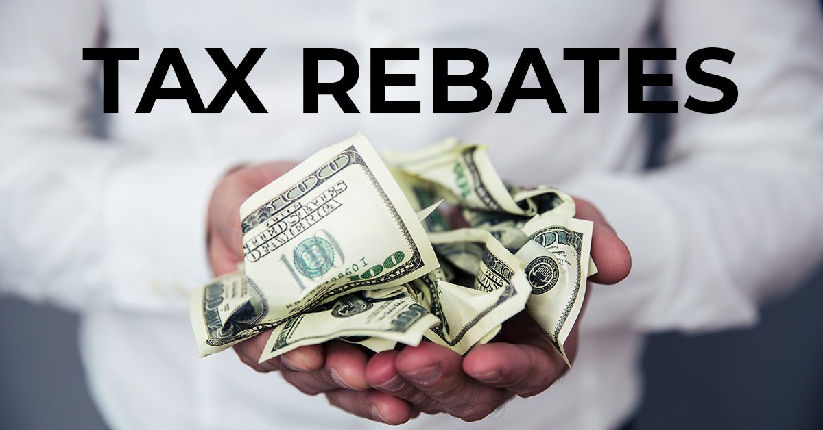 man holding wadded cash in hand with Tax Rebate text at the top